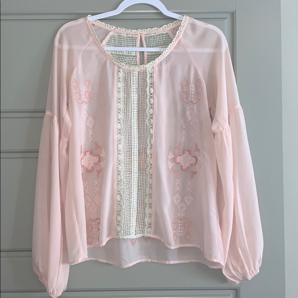 light pink sheer blouse.